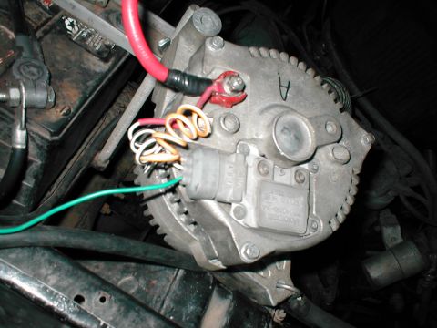 1979 Ford Bronco - Engine-bay close-up of a Motorcraft alternator with an integrated voltage regulator, showing the cast aluminum case, part-number label and…
