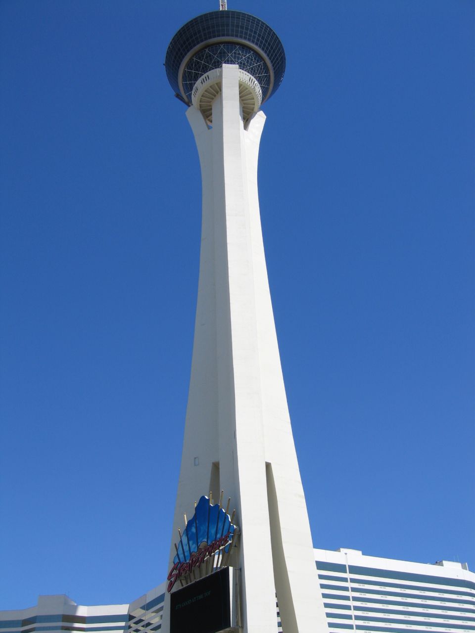 Las Vegas Stratosphere tower against clear blue sky with casino sign at the base