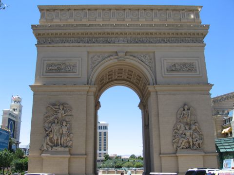 2003 BMW Z4 - The Paris Las Vegas hotel's replica of the Arc de Triomphe stands against a clear blue sky, with other Las Vegas Strip buildings visible.