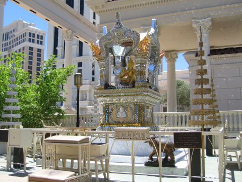 2003 BMW Z4 - A decorative shrine with intricate details and a golden Buddha figure is displayed outdoors.