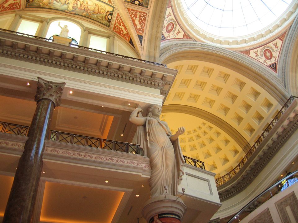 Interior architecture with statues and a dome ceiling, SuperMotors logo visible
