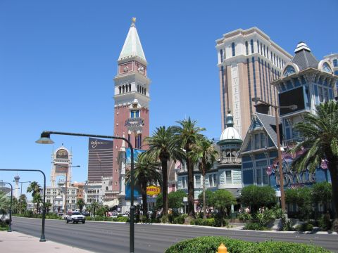 2003 BMW Z4 - A white sedan drives down the Las Vegas Strip, passing by buildings designed to resemble Venetian architecture.