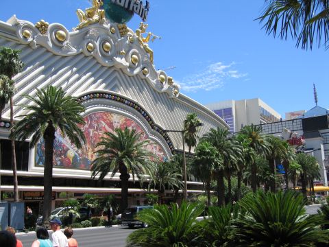2003 BMW Z4 - A view of a large building facade with decorative elements and a mural, set against a bright blue sky with palm trees.