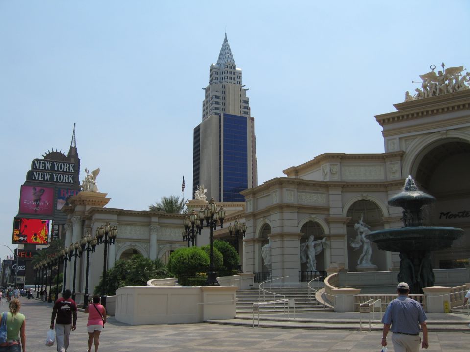 Street scene with New York New York hotel and casino, a fountain, and people walking