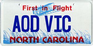 1985 Ford LTD Crown Victoria - A North Carolina license plate with the phrase 'First in Flight' and 'AOD VIC' displayed.