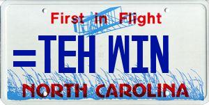 1985 Ford LTD Crown Victoria - Graphic of a North Carolina First in Flight vanity license plate, not a technical document.
