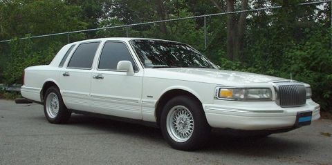 1997 Ford Crown Victoria - This 1995 Lincoln Town Car is shown from the front three-quarter view.