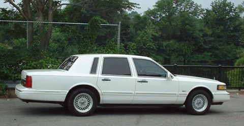 1997 Ford Crown Victoria - This 1997 Lincoln Town Car is a white sedan seen from the side.
