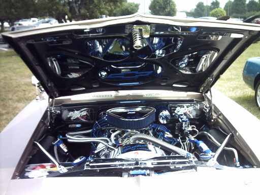 Engine bay with chrome and blue accents, air intake, and custom wiring