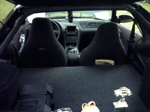 1995 Ford Probe - Interior of a 1995 Ford Probe, including seats, dashboard, and items in the cargo area.