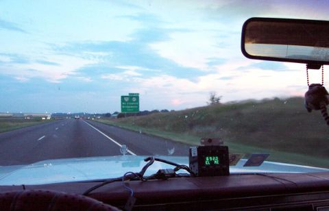 1985 Ford LTD Crown Victoria - Driving on the highway at dusk, with a radar detector visible on the dashboard.