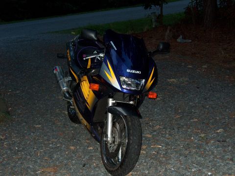 2002 Suzuki TL1000R - A blue and yellow Suzuki motorcycle is parked on a gravel surface at night.