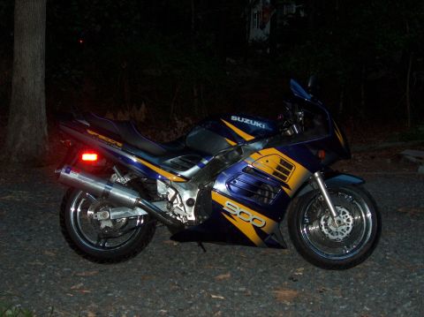 2002 Suzuki TL1000R - A blue and yellow Suzuki motorcycle is parked outdoors at night.
