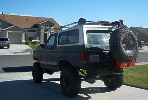 1986 Ford Bronco - This modified 1986 Ford Bronco is parked in a driveway with a house in the background.