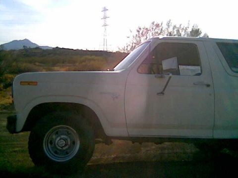 1980 Ford Bronco - Side view of a white Ford Bronco in a dry, outdoor setting.