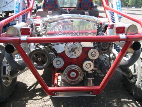 1993 Ford Taurus - Rear view of a red tube-frame sand rail or buggy showing a transversely mounted V6 with a polished YAMAHA-embossed cam cover, exposed serpe…
