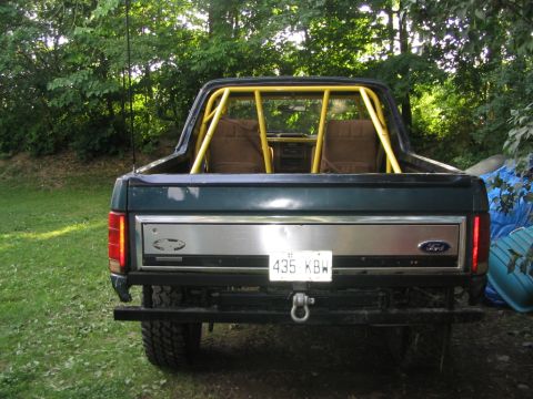 1986 Ford Bronco - This 1986 Ford Bronco features a custom yellow roll cage visible through the rear window.