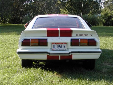 1978 Ford Mustang II - Rear view of a white 1978 Ford Mustang II Cobra II with red racing stripes and a California collector plate.