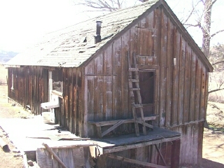1986 Ford Bronco - An old wooden building with a weathered exterior and a ladder against the side.
