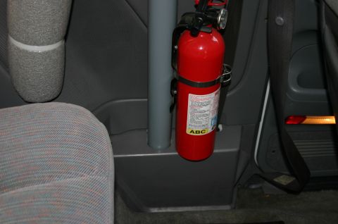 1994 Ford Bronco - Interior view of a vehicle showing a fire extinguisher attached to a roll bar.