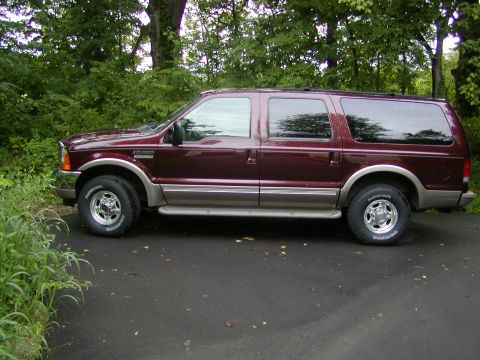 2001 Ford Excursion - Side profile of a maroon 2000 Ford Excursion SUV parked on a driveway.