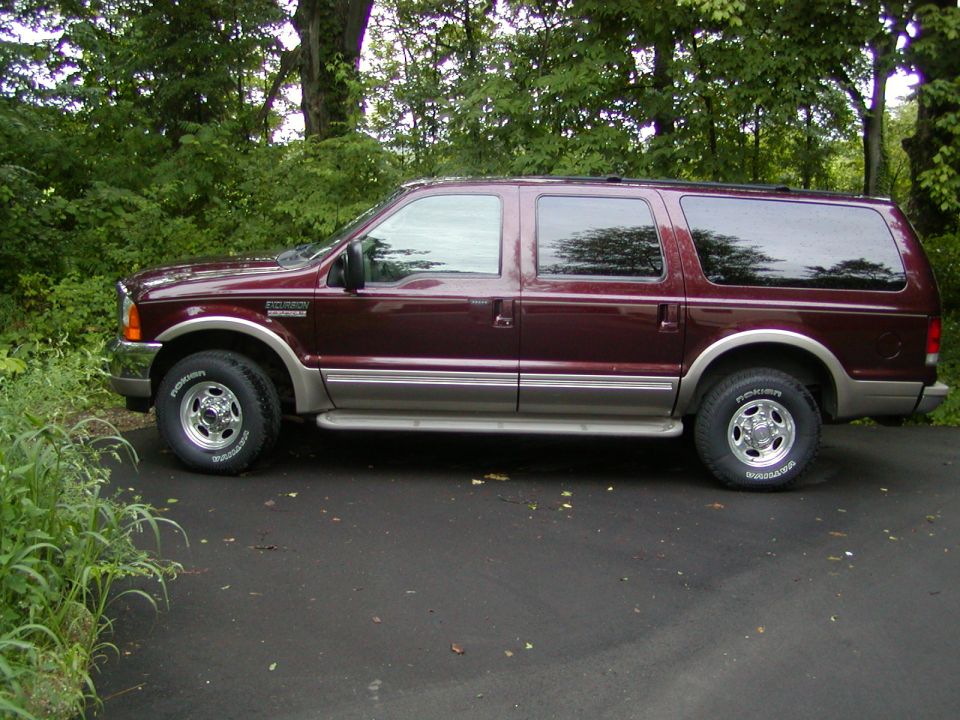 Maroon 2000 Ford Excursion SUV, side view