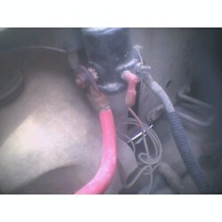 1981 Ford Bronco - Detail of wiring within the engine bay, showing various cables and connections.