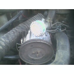 1981 Ford Bronco - Engine part detail, likely from a vehicle, with visible hoses and a cap.