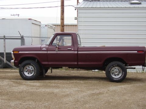 1979 Ford F-250 - Side profile of a maroon 1979 Ford F-250 pickup truck parked outdoors.