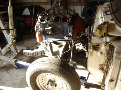 1963 Ford Galaxie - Engine removal in progress, with the front wheel and chassis visible.