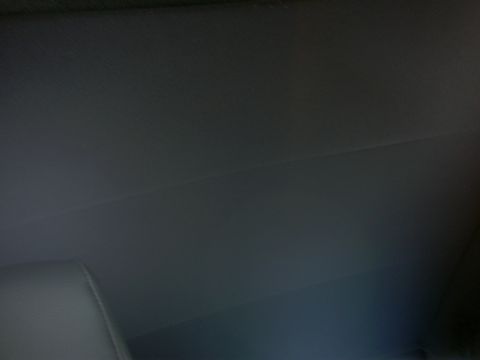 2005 Ford Mustang - The interior ceiling of a vehicle is visible, along with a portion of a seat. A Supermotors.net logo is in the lower right corner.