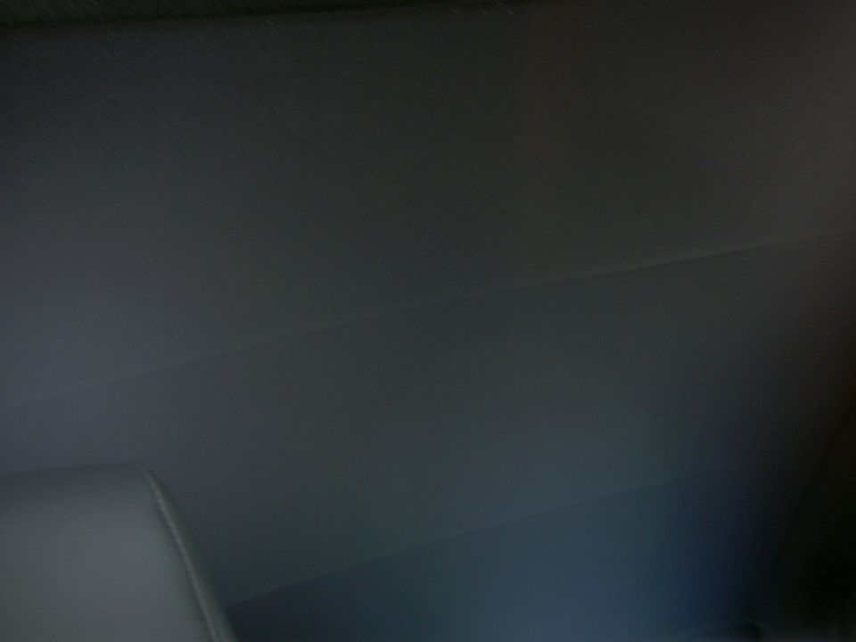 Car interior ceiling and part of a seat. Supermotors.net logo in corner