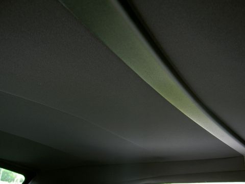 2005 Ford Mustang - The interior ceiling of a car is visible, with a prominent bar across the top.