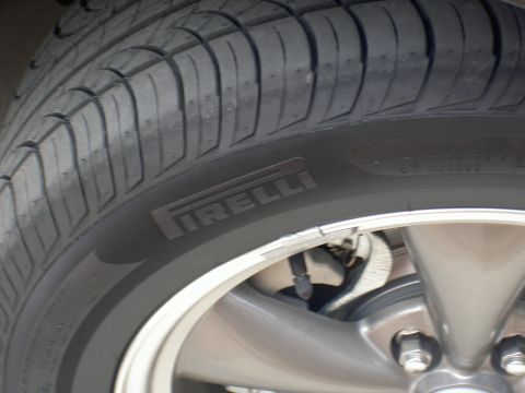 2005 Ford Mustang - Pirelli tire mounted on a car's alloy wheel.