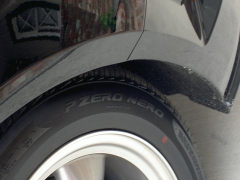 2005 Ford Mustang - A close-up view of the tire and fender area of a vehicle.