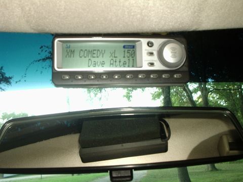 2000 Ford Taurus - The interior of a vehicle is visible, focusing on the satellite radio display and rearview mirror.