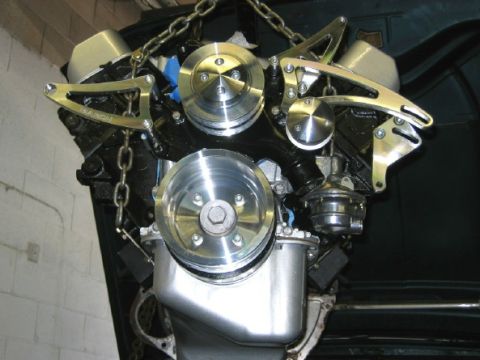 1994 Ford Bronco - Engine assembly with chrome pulleys and chains, likely a custom build or swap.