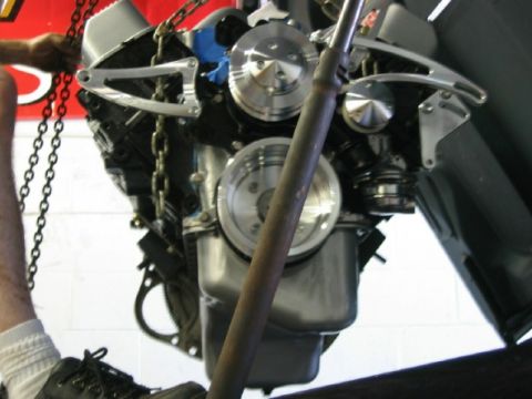 1994 Ford Bronco - Engine installation in progress, showing the front of the motor with polished accessories.
