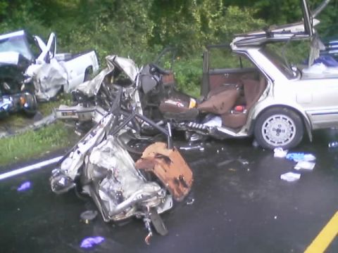 1985 Ford Bronco - The aftermath of a severe multi-vehicle collision on a wet roadway.