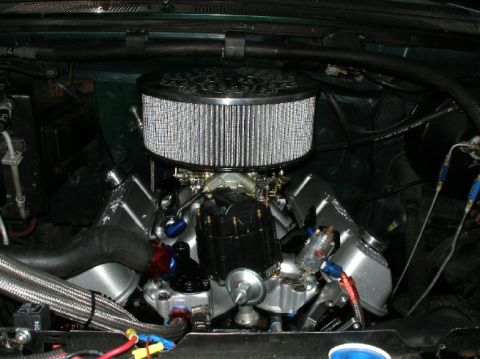 1994 Ford Bronco - Close-up view of a modified engine bay, showing custom components and wiring.