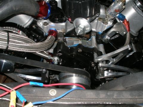1994 Ford Bronco - Close-up view of engine components, including braided hoses and wiring, with a SuperMotors watermark.