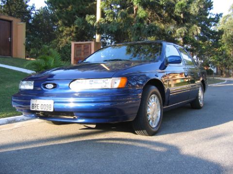 1995 Ford Taurus - Blue 1995 Ford Taurus sedan parked on a street, showing its front and side profile.