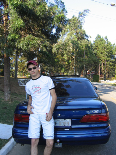 1995 Ford Taurus - Man poses with his blue 1995 Ford Taurus, showing the rear of the vehicle.
