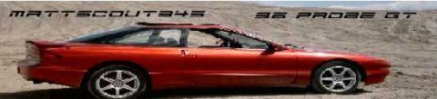 1996 Ford Probe - A red 1996 Ford Probe GT is parked in a sandy, outdoor location.