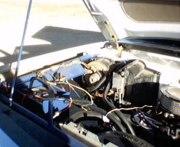 1981 Ford Bronco - The engine bay of a vehicle is shown with various components and wiring. The Supermotors logo is present in the lower right corner.