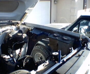 1981 Ford Bronco - The engine bay of a Ford Bronco is visible with the hood open, revealing the spare tire and engine components.