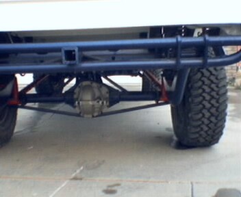 1981 Ford Bronco - The rear underside of a vehicle is shown with a focus on the axle and suspension components.