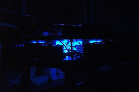 1985 Ford LTD Crown Victoria - The trunk interior is illuminated with blue lighting, revealing wiring and components.