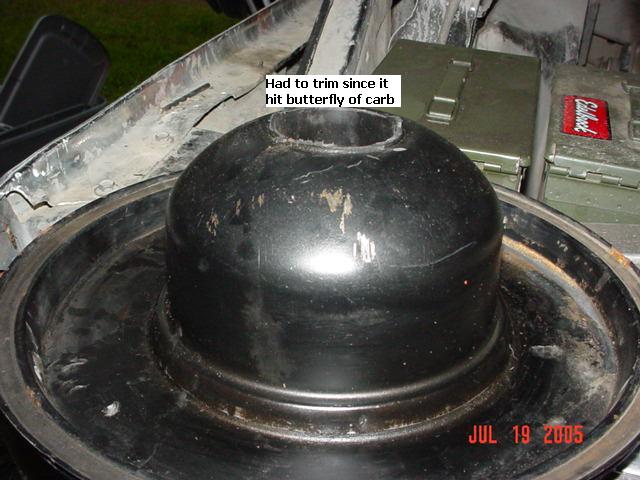 Black round air cleaner over carburetor with Edelbrock label and note about trimming