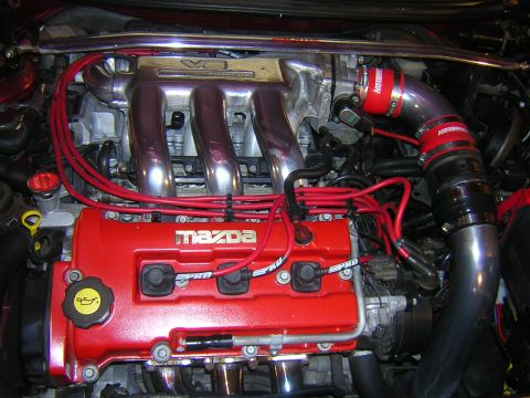 1995 Ford Probe - Close-up view of a modified Mazda engine bay, showing the intake and ignition systems.